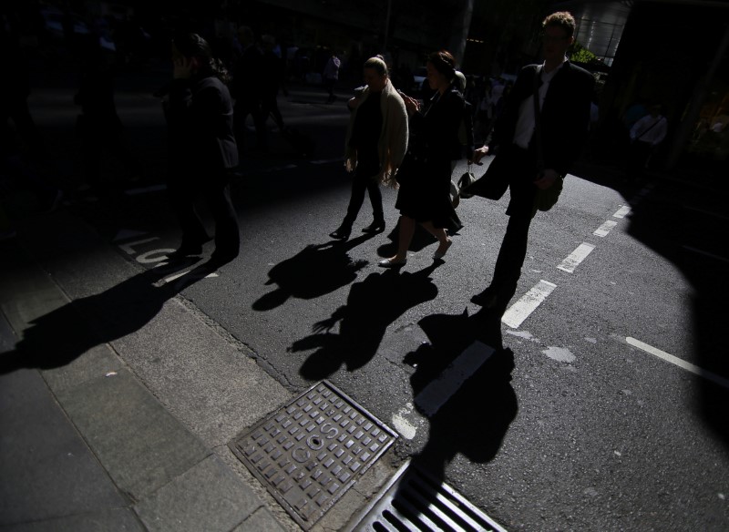 Office workers cross a street in Sydney