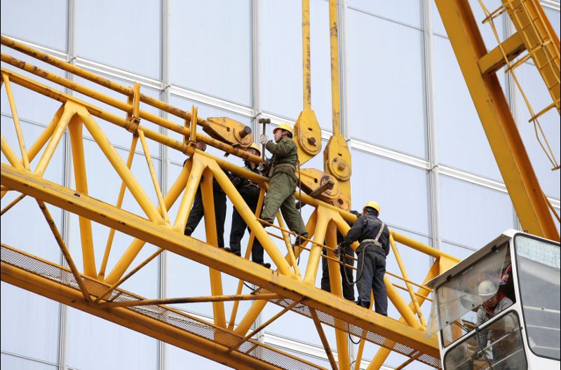 Labourers work at a construction site in Beijing's central business area