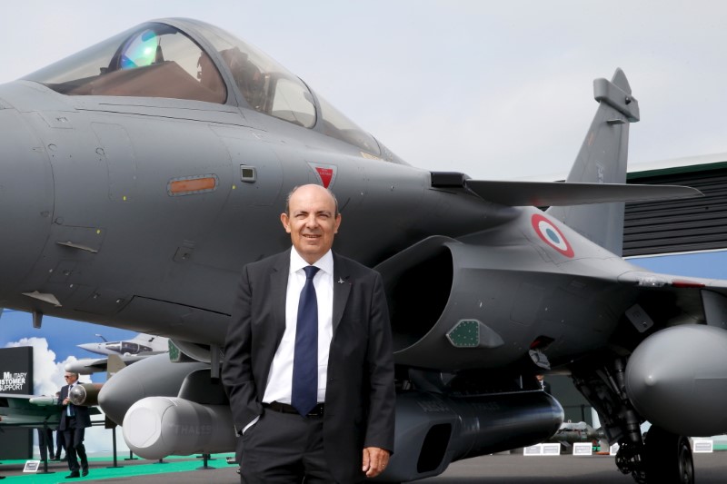 FILE PHOTO: Trappier poses for pictures in front of an Dassault Rafale C fighter during the 51st Paris Air Show at Le Bourget airport near Paris