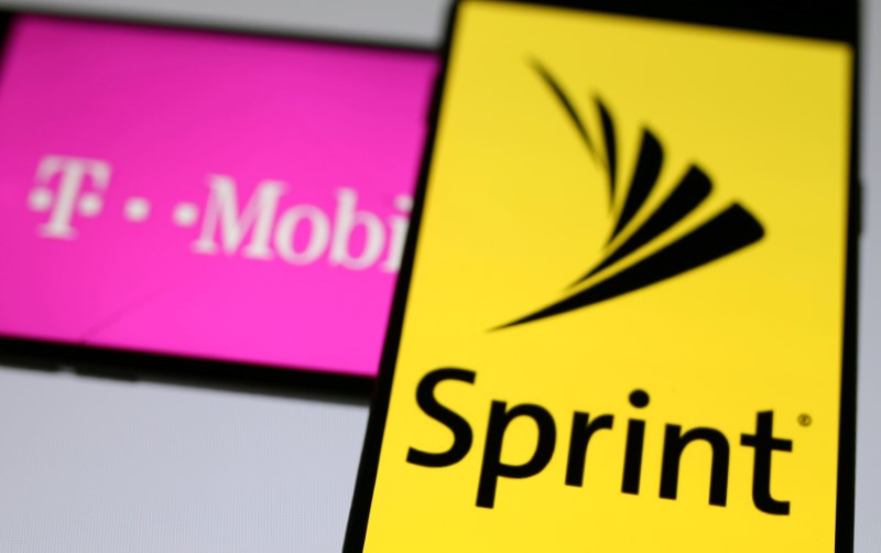 FILE PHOTO: Smartphones with the logos of T-Mobile and Sprint are seen in this illustration