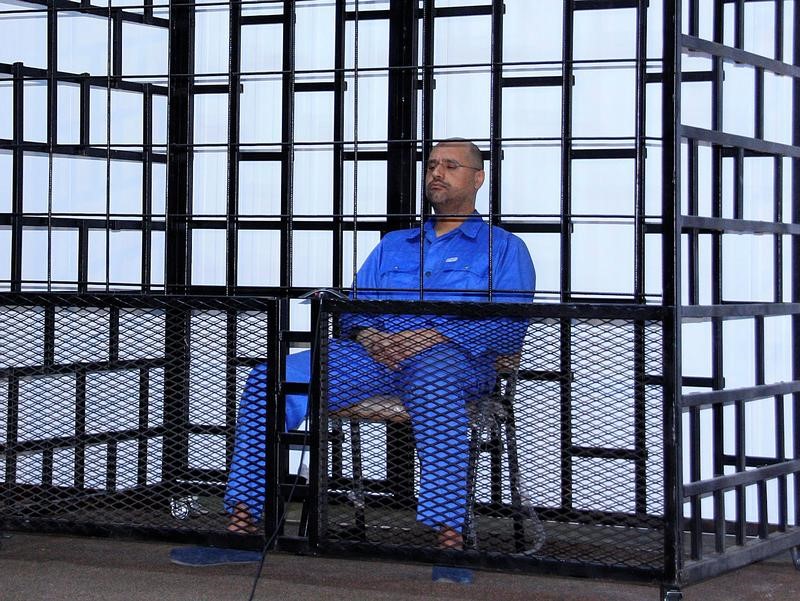 FILE PHOTO: Saif al-Islam Gaddafi, son of late Libyan leader Muammar Gaddafi, attends a hearing behind bars in a courtroom in Zintan
