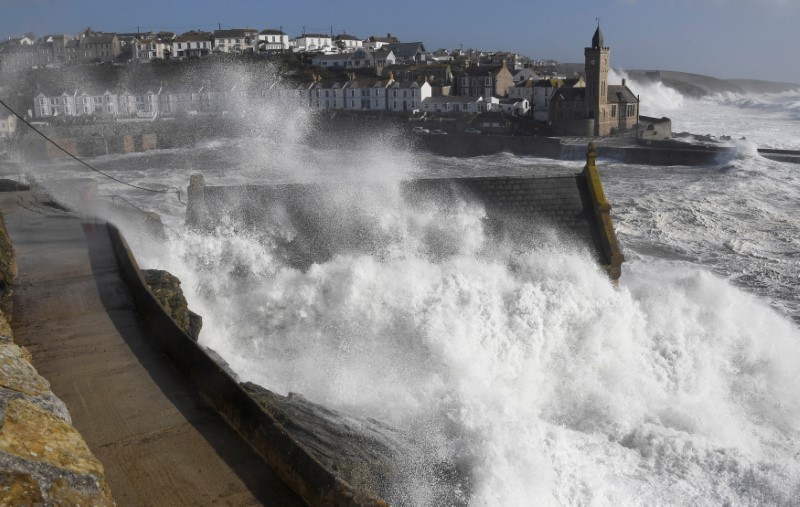 Large waves crash along sea defences and the harbour as storm Ophelia approaches Porthleven in Cornwall, south west Britain