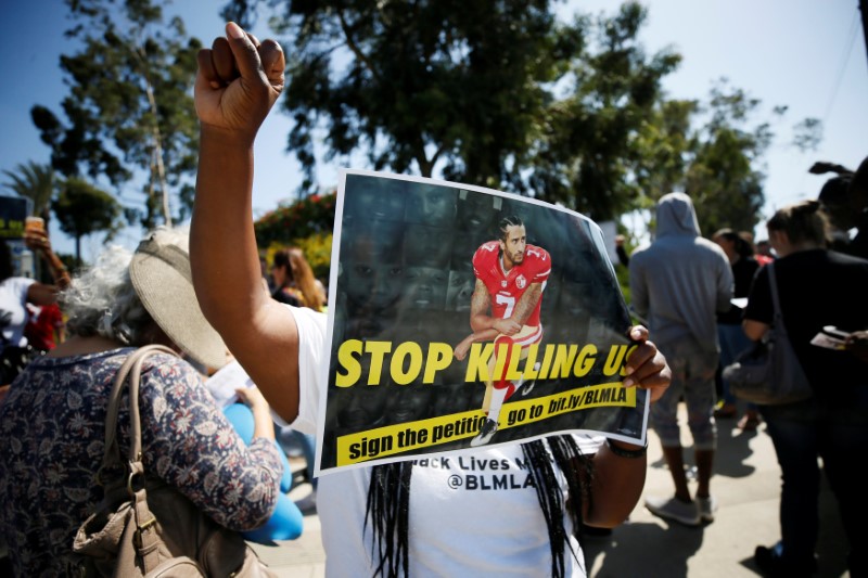 A protester demonstrates in support of NFL players who 