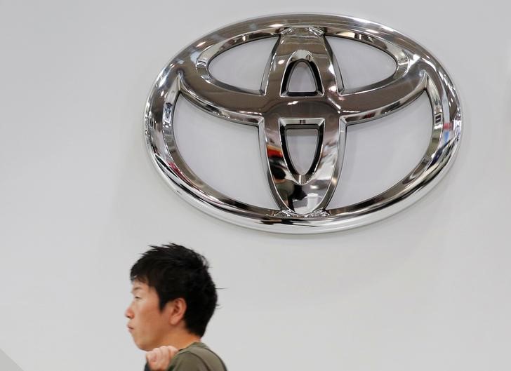A man walks past a Toyota Motor Corp logo at the company's showroom in Tokyo
