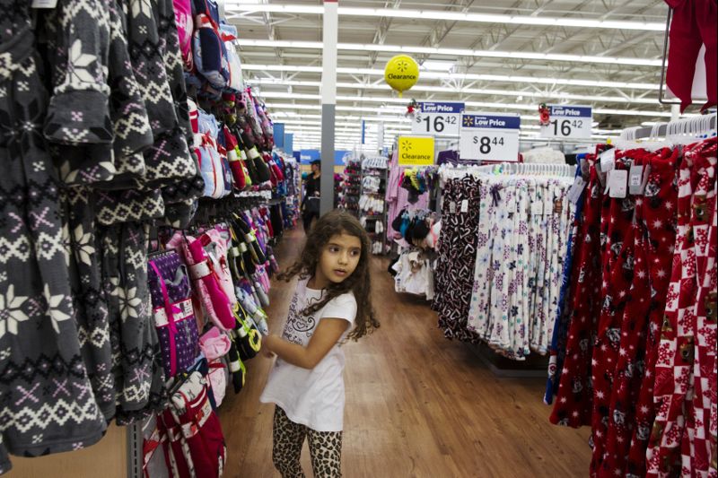 FILE PHOTO: A girl looks at pajamas while shopping at a Walmart store in Secaucus, New Jersey