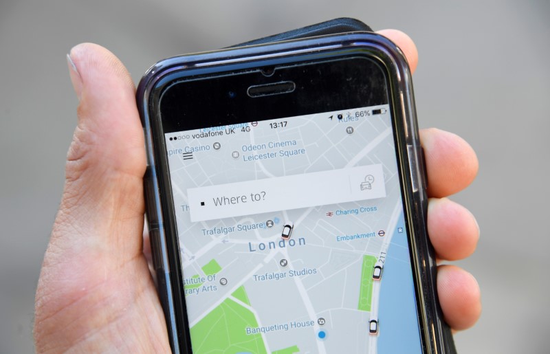 FILE PHOTO: A photo illustration shows the Uber app on a mobile telephone, as it is held up for a posed photograph in central London