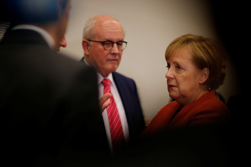 German Chancellor Merkel and CDU/CSU chair Kauder attend a meeting at the Bundestag in Berlin