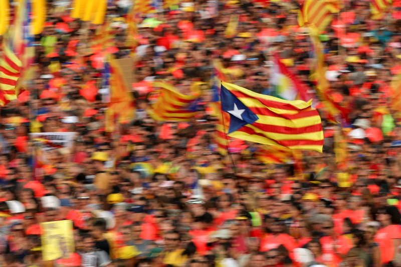 FILE PHOTO: People carry a Catalan separatist flag during a rally on Catalonia's national day 'La Diada' in Barcelona