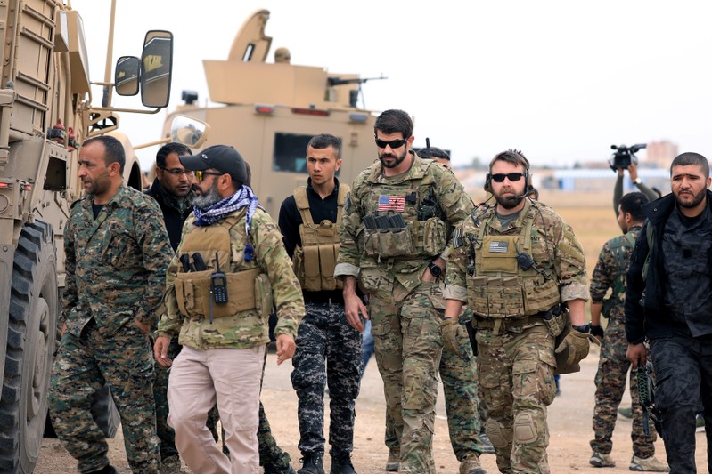 Syrian Democratic Forces and U.S. troops are seen during a patrol near Turkish border in Hasakah