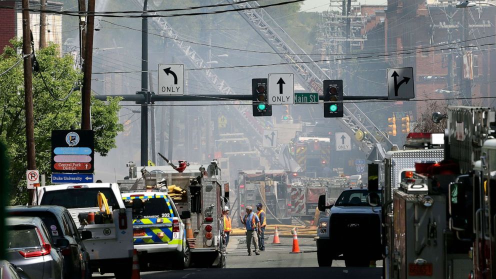Firefighters and emergency personnel work the scene of an explosion and building fire in downtown Durham, N.C., April 10, 2019.