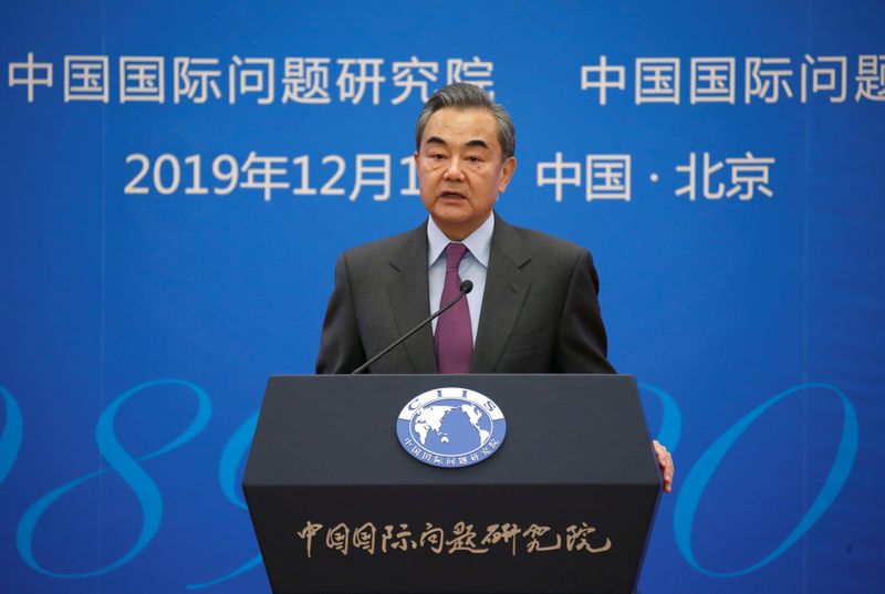 Chinese Foreign Minister Wang Yi delivers a speech at an annual symposium on international situation and China's diplomacy in Beijing