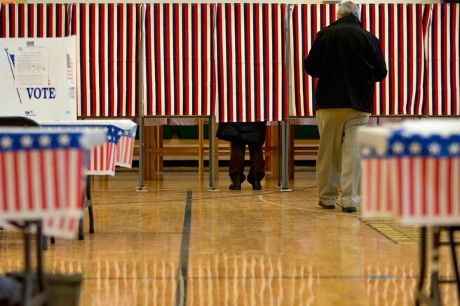 People cast their votes in the presidential primary at Windham High School in Windham, N.H., Tuesday, Feb. 9, 2016, during the New Hampshire primary. (AP Photo/Jacquelyn Martin)