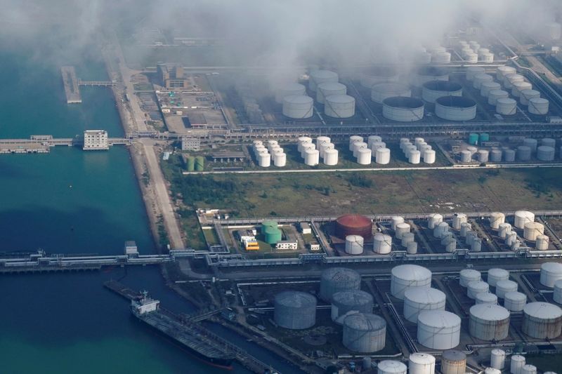 FILE PHOTO: Oil and gas tanks are seen at an oil warehouse at a port in Zhuhai
