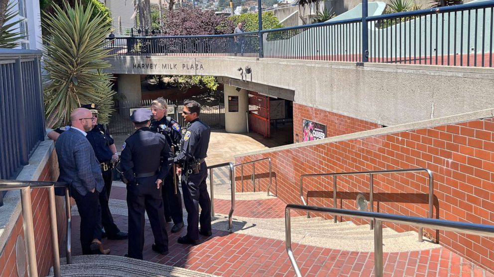 PHOTO: Police personnel confer outside the entrance to the Castro Muni Metro station following a shooting in San Francisco, June 22, 2022.