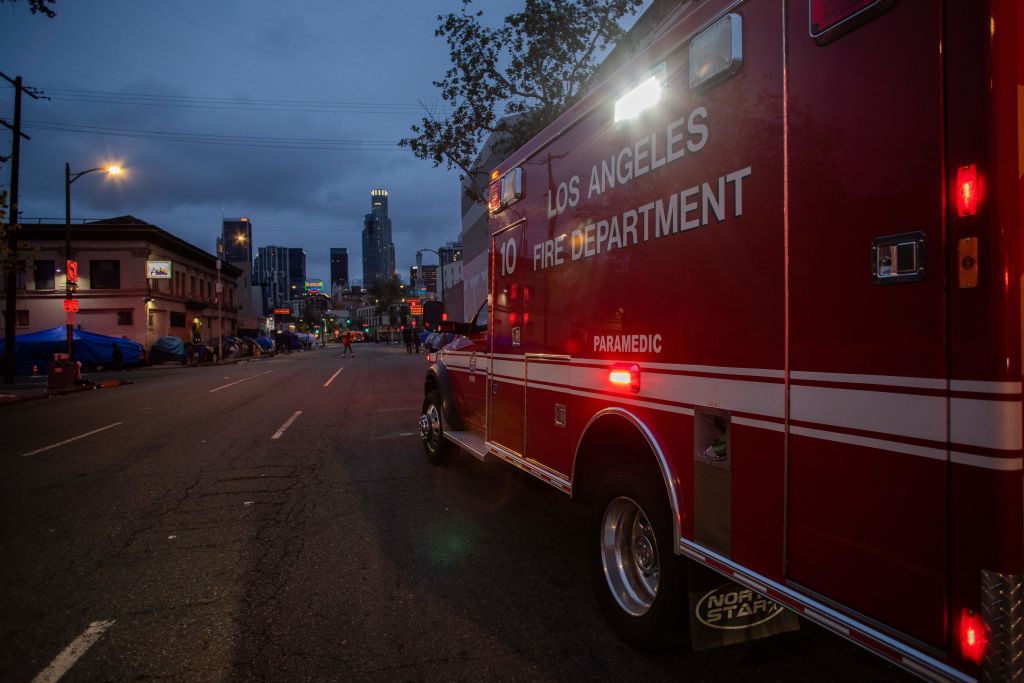 An ambulance of the LAFD Station No9 rides along Skid Row. (Photo by APU GOMES/AFP via Getty Images)