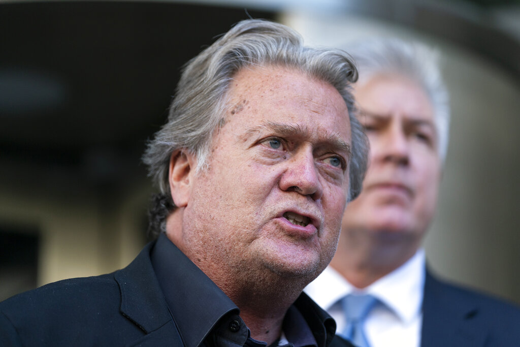 Former White House strategist Steve Bannon, left, speaks with reporters as he departs federal court on Tuesday, July 19, 2022, in Washington. Accompanying Bannon is his attorney M. Evan Corcoran. Bannon, a one-time adviser to former President Donald Trump, faces criminal contempt of Congress charges after refusing for months to cooperate with the House committee investigating the Jan. 6, 2021, Capitol insurrection. (AP Photo/Alex Brandon)