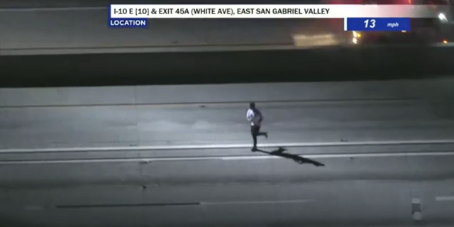 The suspect is seen running along the interstate after police ram the suspected stolen construction truck he was driving into a median. He was eventually arrested with the help of a K-9 officer.