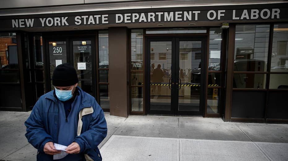 A man stands in front of the New York State Labor Department