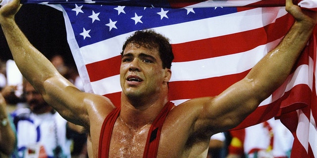 Kurt Angle of the United States holds the American flag at the free-style wrestling competition during the Summer Olympics at the Georgia World Congress Center in Atlanta, Georgia.
