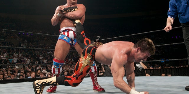 Kurt Angle puts Eddie Guerrero in the ankle lock.