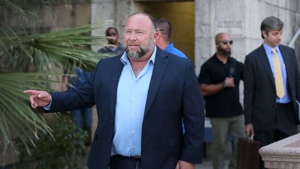 PHOTO: Alex Jones steps outside of the Travis County Courthouse, to do interviews with media after he was questioned under oath about text messages and emails by lawyer Mark Bankston, in Austin, Texas, Aug. 3, 2022. 