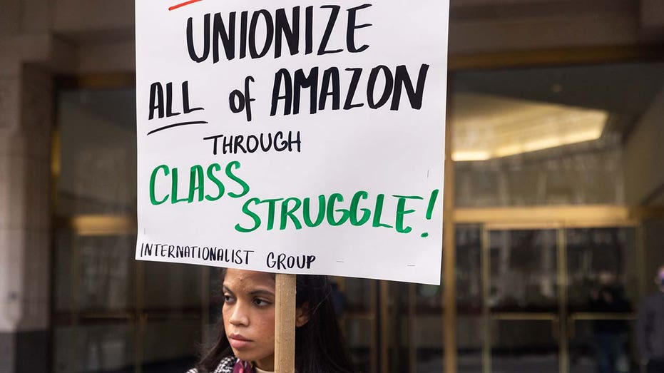 An Amazon worker holds a pro-union sign