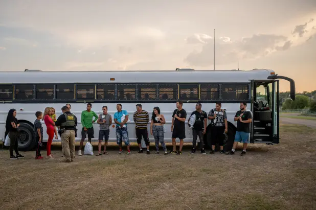 Migrants prepare to board a Border Patrol bus on May 20, 2022, in Eagle Pass, Texas. Brandon Bell/Getty Images