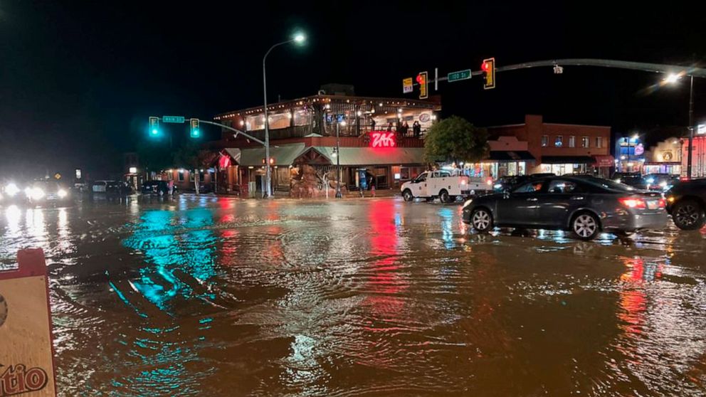 PHOTO: Vehicles navigate high waters at the intersection of South Main Street and 100 South in Moab, Utah on Aug. 20, 2022, in an image released by the City of Moab. Nearly an inch of rain fell in the area in 20 minutes, causing flooding in places.