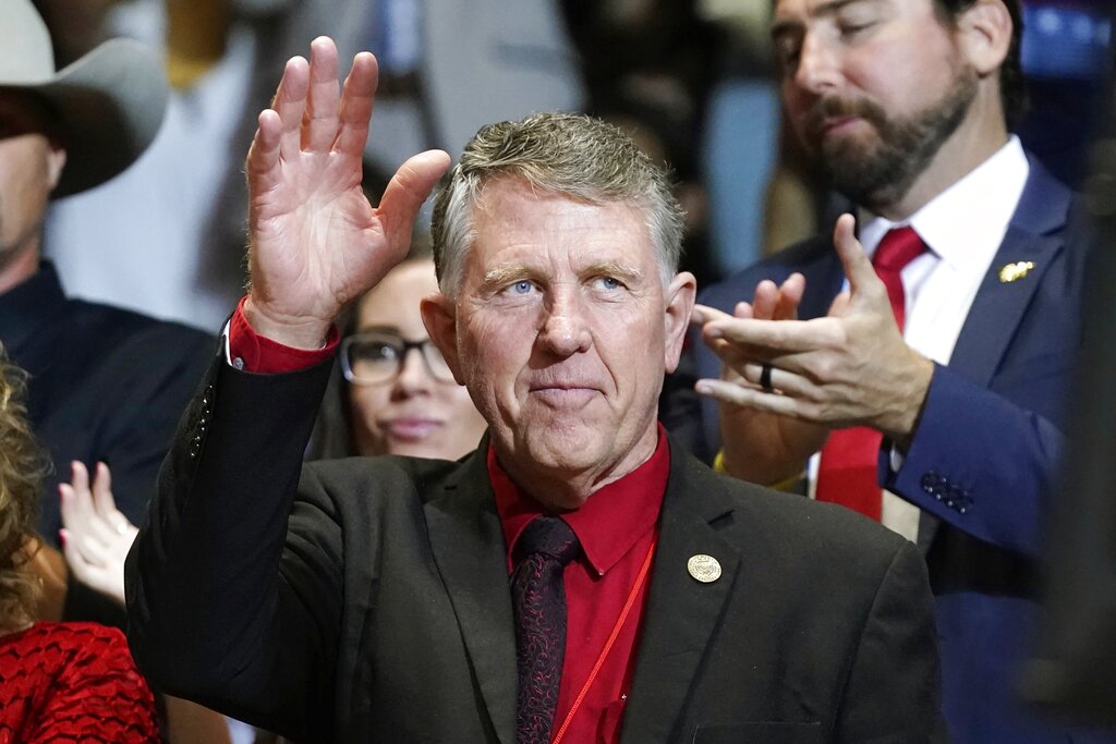 Former Republican Arizona state Sen. David Farnsworth waves to a cheering crowd as he is introduced by former President Donald Trump as Trump speaks at a Save America rally Friday, July 22, 2022, in Prescott, Ariz. Farnsworth is mounting a primary challenge to the current Arizona Speaker of the House in Republican Rusty Bowers. (AP Photo/Ross D. Franklin)