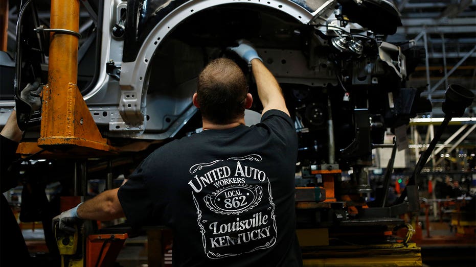 Worker in United Auto Workers shirt in Ford factor