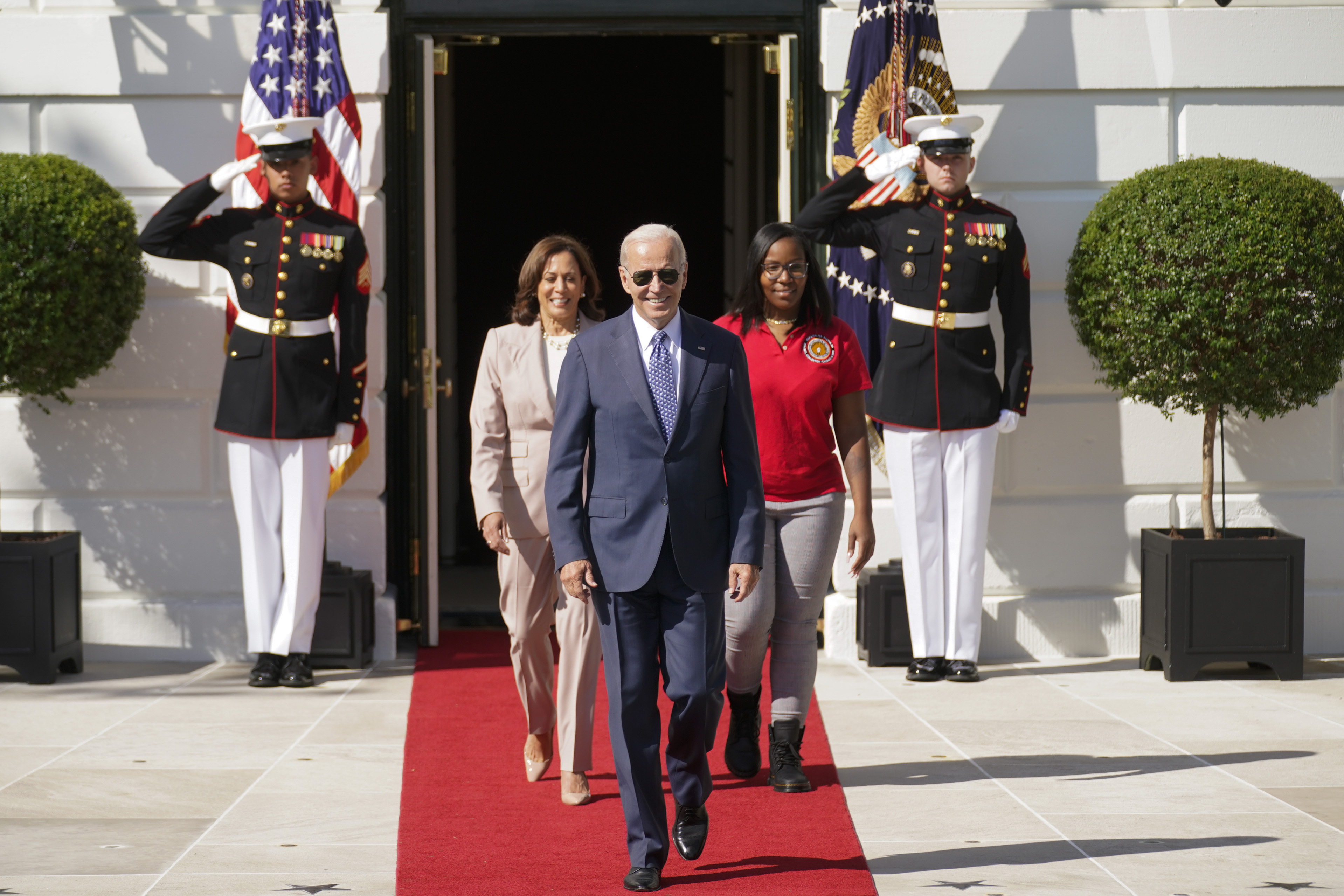 President Joe Biden arrives with Vice President Kamala Harris and Lovette Jacobs, a fifth year IBEW Local 103 electrical apprentice in Boston, for a ceremony where Biden will sign H.R. 5376, the Inflation Reduction Act of 2022, on the South Lawn of the White House in Washington, Tuesday, Sept. 13, 2022. (AP Photo/Andrew Harnik)