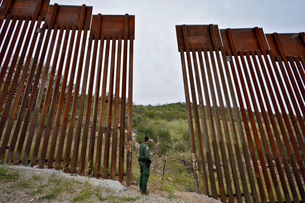 PHOTO: Border Patrol agent Jesus Vasavilbaso looks into Mexico at a breach in the 30-foot-high border wall where a gate was never installed due to a halt in construction, Sept. 8, 2022, in Sasabe, Ariz. 