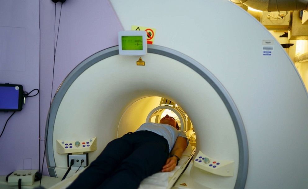PHOTO: a person getting a CAT Scan.