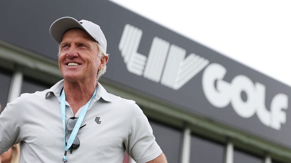 Greg Norman watches play on the driving range