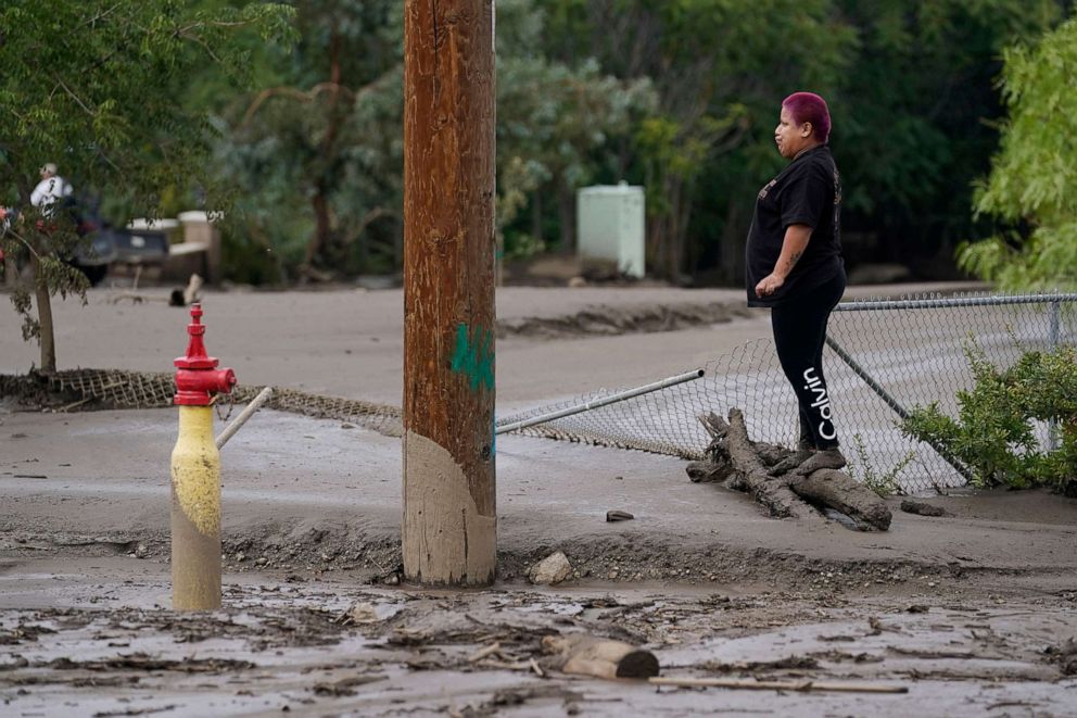 PHOTO: Perla Halbert gets a look at the damage to her property, unable to access it due to deep mud in her driveway, in the aftermath of a mudslide, Sept. 13, 2022, in Oak Glen, Calif.