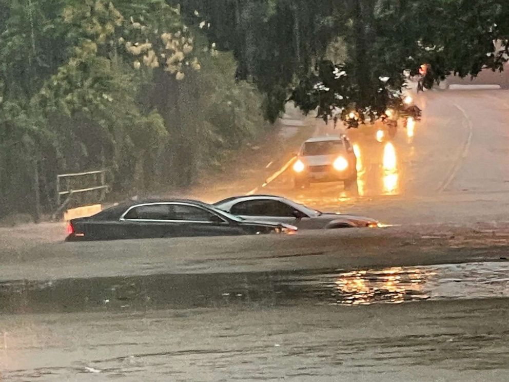 PHOTO: In this file photo taken on August 22, 2022 a handout photo provided by the Dallas Police Department shows vehicles sitting in flood waters along a street in Dallas, Texas.