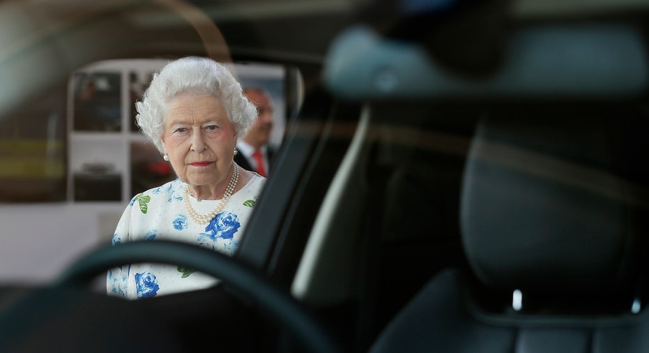 Queen Elizabeth peers through the window of a Range Rover