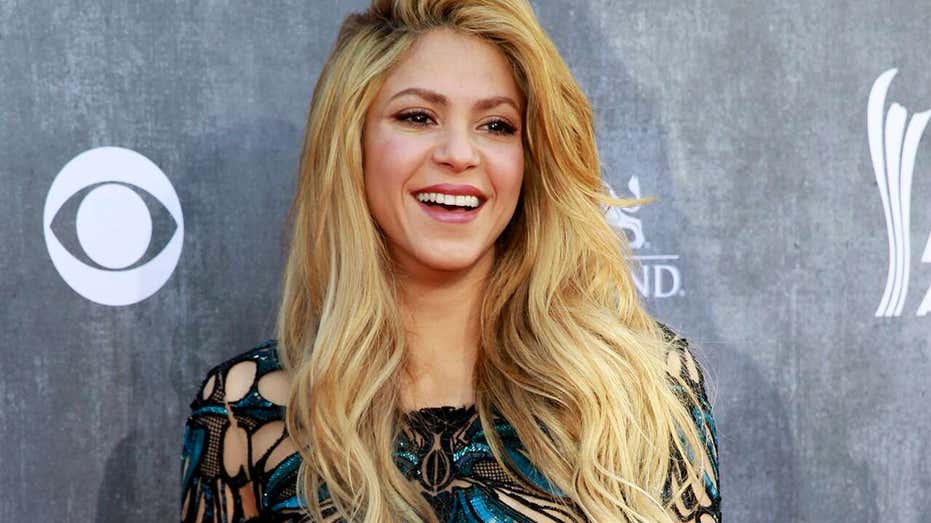 Shakira smiling at press event