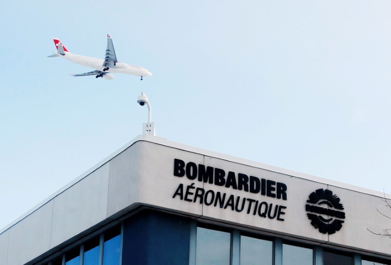 FILE PHOTO - A plane flies over a Bombardier plant in Montreal