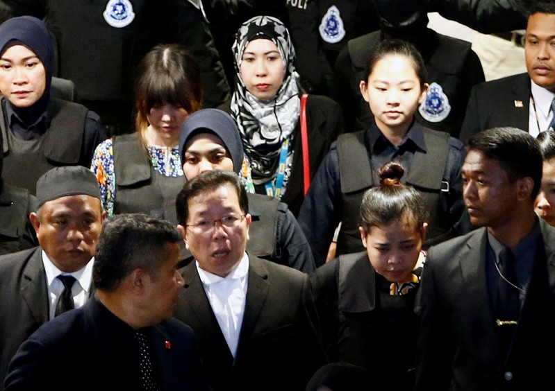 Indonesian Siti Aisyah and Vietnamese Doan Thi Huong, who are on trial for the killing of Kim Jong Nam, the estranged half-brother of North Korea's leader, are escorted as they revisit the Kuala Lumpur International Airport 2 in Sepang, Malaysia