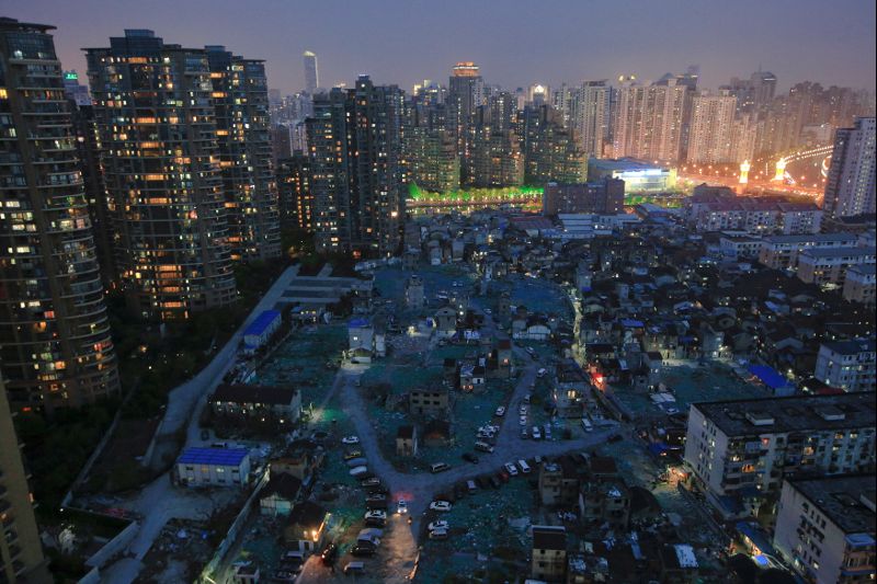 FILE PHOTO: A night view of the old houses surrounded by new apartment buildings at Guangfuli neighbourhood in Shanghai