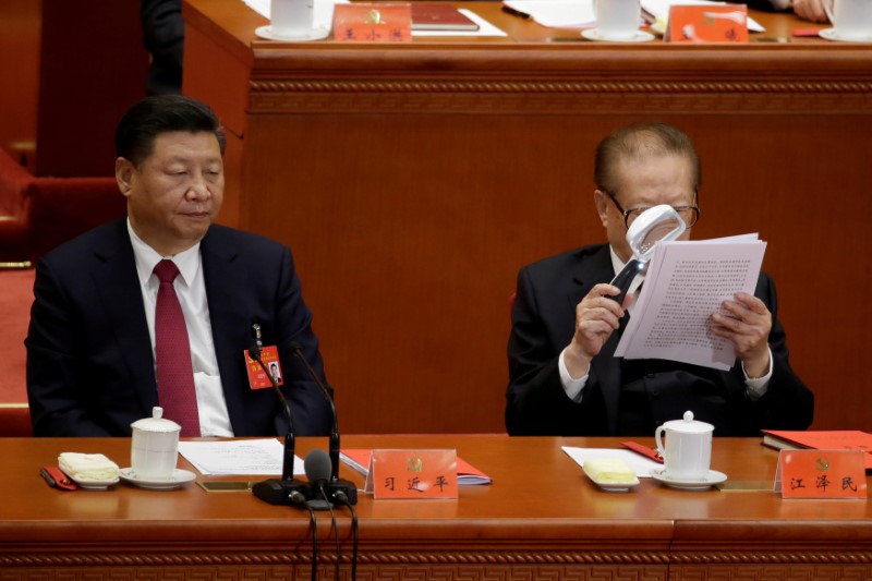 Chinese President Xi Jinping and former Chinese president Jiang Zemin are seen during the closing session of the 19th National Congress of the Communist Party of China at the Great Hall of the People, in Beijing