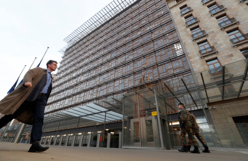 People walk past the Europa Building which was evacuated after toxic fumes from kitchen drains, forcing the EU to switch the venue of its summit in Brussels less than 24 hours before leaders were due to begin the two-day meeting, in Brussels