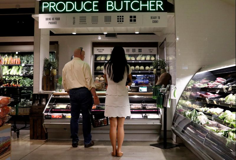 FILE PHOTO: Customers shop at a Whole Foods store in New York