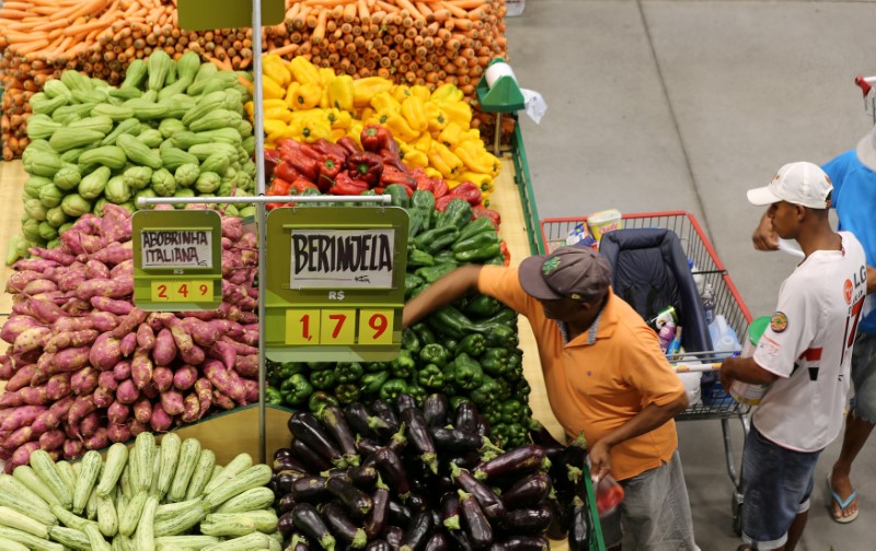 FILE PHOTO - Consumers shop for food at a market in Sao Paulo