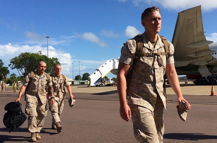 U.S. Marines walk after disembarking a plane after they arrived for the sixth annual Marines' deployment at Darwin in northern Australia