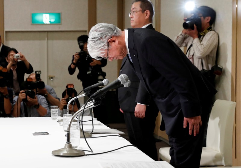 Kobe Steel President and CEO Hiroya Kawasaki bows during a news conference in Tokyo