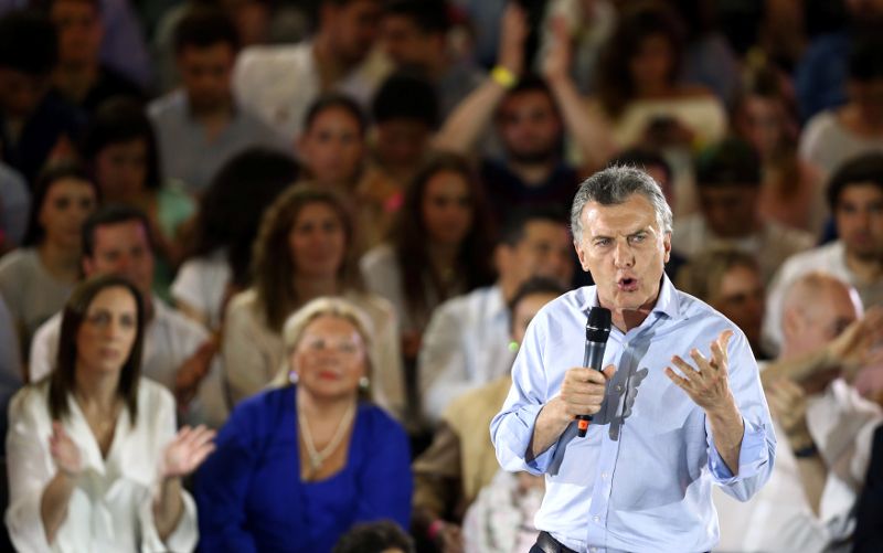 Argentina's President Mauricio Macri speaks in front of Buenos Aires province governor Maria Eugenia Vidal (L, back) and Lower House candidate Elisa Carrio (C, back) during a campaign rally ahead of mid-term elections in Buenos Aires