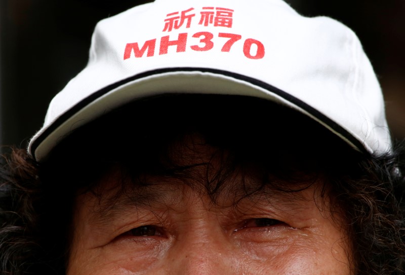 A family member of a passenger aboard Malaysia Airlines flight MH370 which went missing in 2014 reacts during a protest outside the Chinese foreign ministry in Beijing