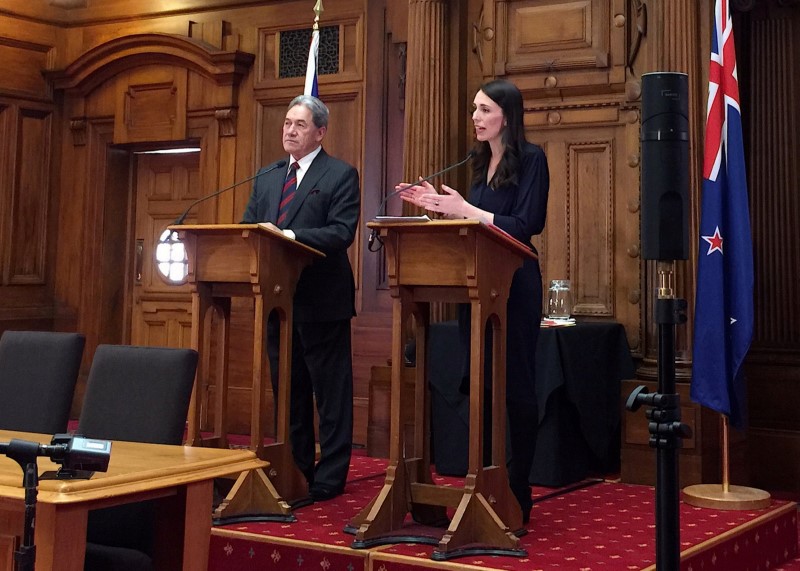 New Zealand's Prime Minister-designate Jacinda Ardern speaks as she stands next to New Zealand First party leader Winston Peters after their meeting in Wellington